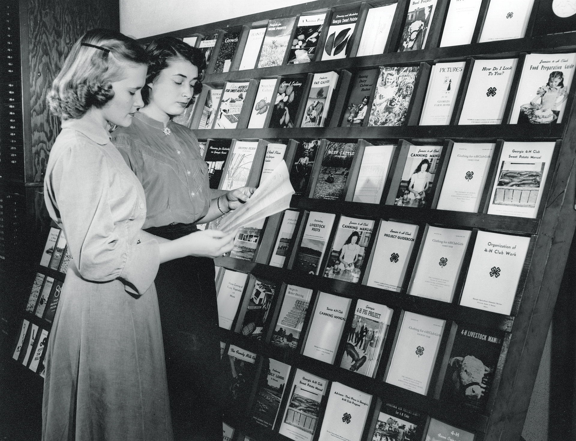 Two girls browse publications